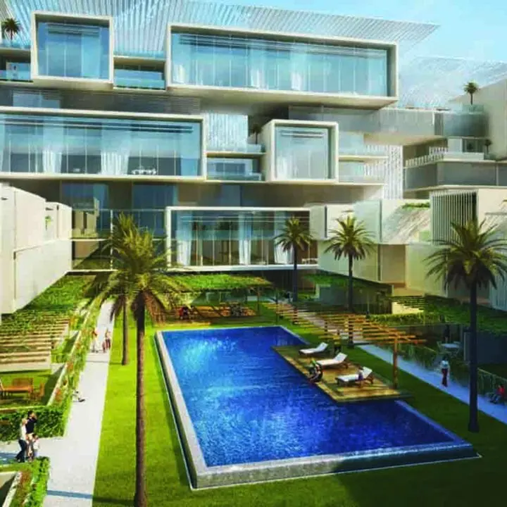 Modern residential building with an outdoor swimming pool and landscaped terrace area.