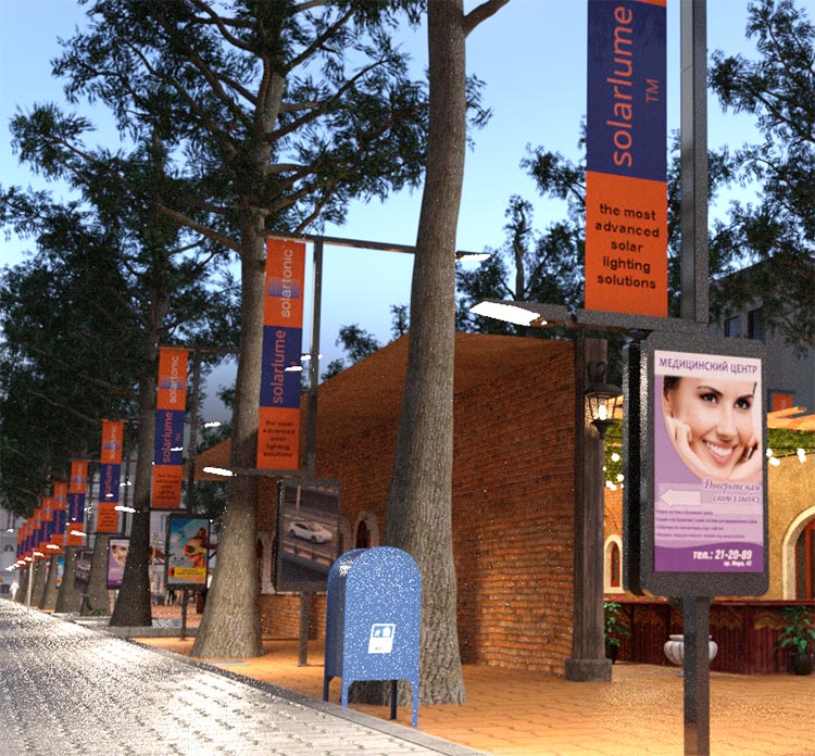A street at dusk with promotional banners on lampposts, an advertisement billboard featuring a smiling person, and a cobblestone pavement next to a brick building.